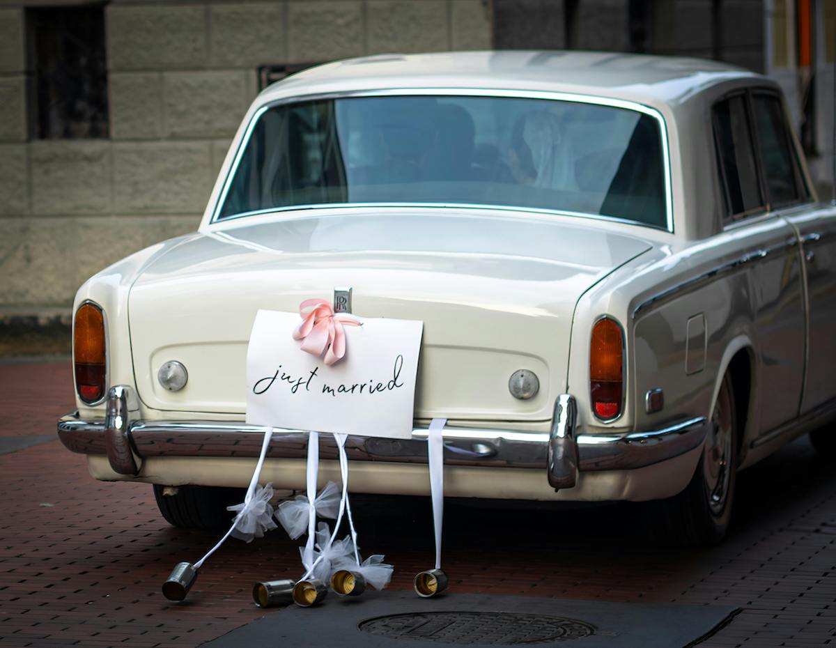 Classic Rolls-Royce with a "Just Married" sign on the back, symbolizing a timeless and elegant wedding exit in Los Angeles.