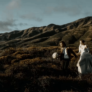 Bride and groom walking hand in hand, symbolizing love and new beginnings.