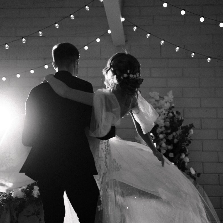 Groom gently holding bride in a tender, magical wedding moment.